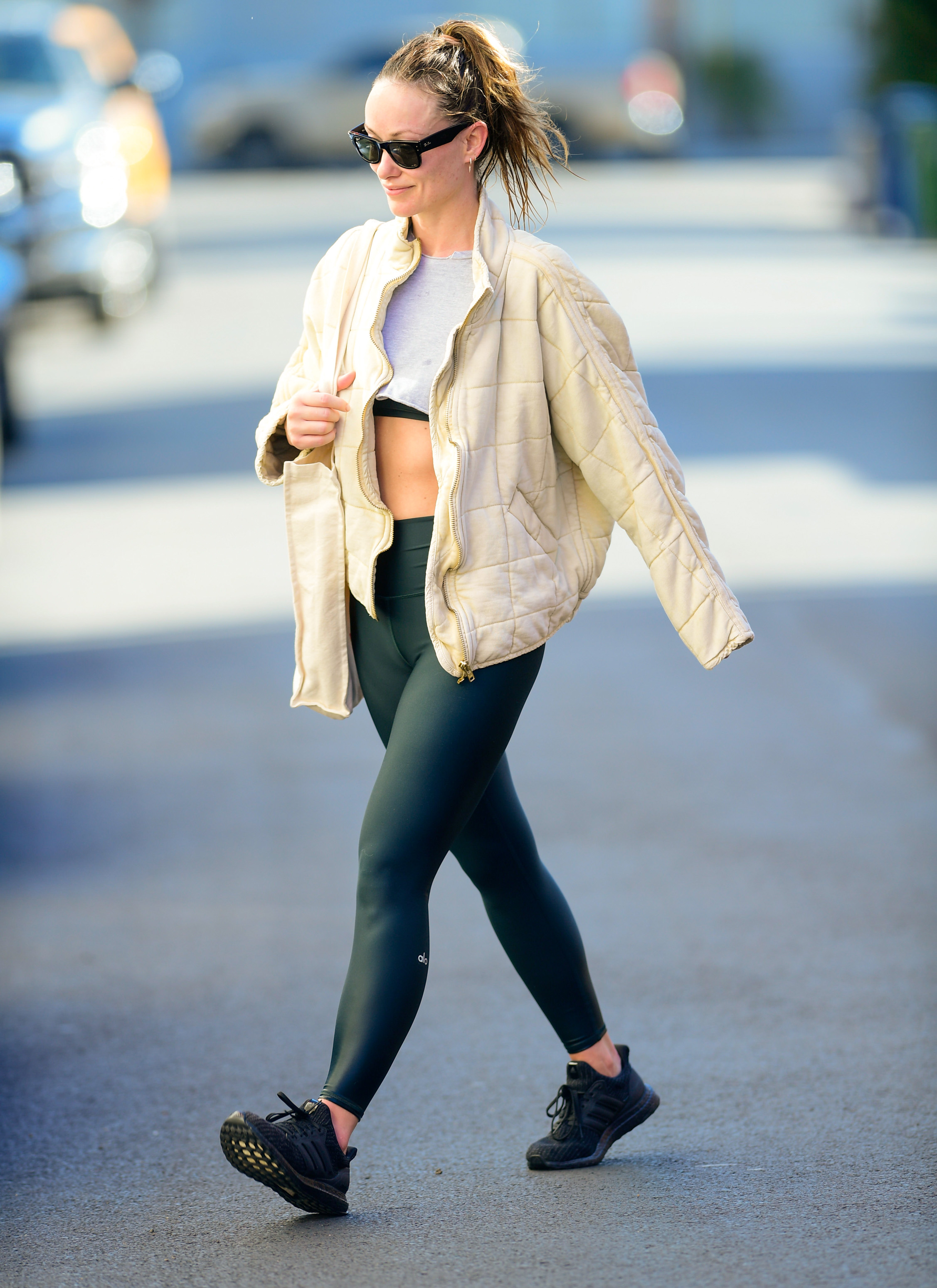 Olivia Wilde in a jacket, crop top and leggings