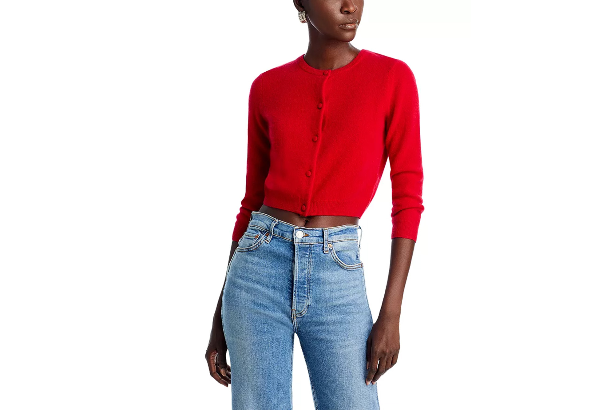 A model in a red cardigan and jeans