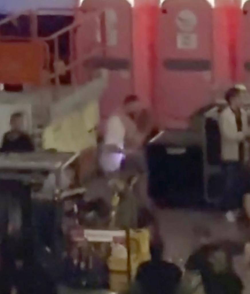 Travis Kelce and Taylor Swift hugging and kissing after her show.